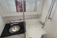Compact bathroom in 2022 Nimbus T11 boat with sink, toilet, and shower.