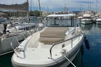 Nimbus T11 2022 boat docked in marina, surrounded by other vessels under a clear sky.