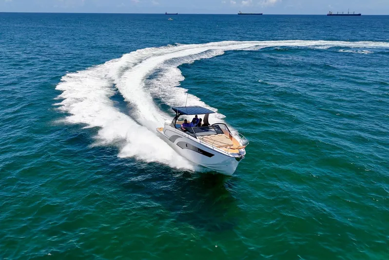 Custom Order Yours Today! Yacht Photos Pics 2025 Hanover 347 Outboard boat cruising on open sea, leaving a wake trail.