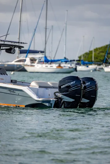  Yacht Photos Pics 2005 Marlago 35 boat with twin Mercury engines on water, sailboats in background.