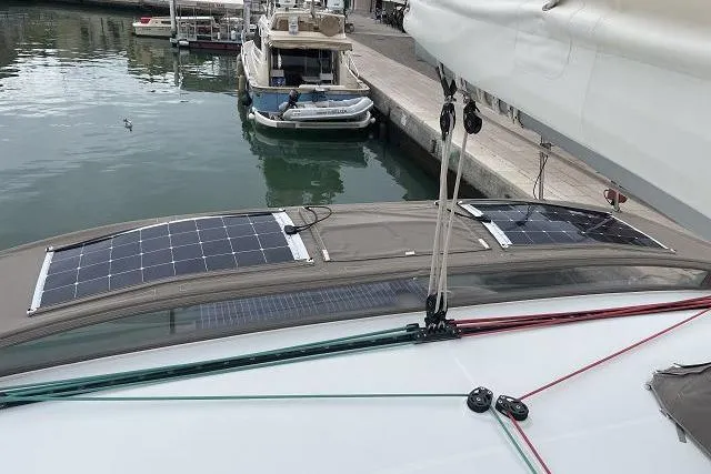 Seafox 1 Yacht Photos Pics 2015 Lagoon 400 S2 catamaran with solar panels docked at a marina.