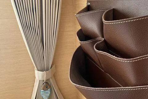 Seafox 1 Yacht Photos Pics Brown leather organizer and beige curtain in 2015 Lagoon 400 S2 yacht interior.