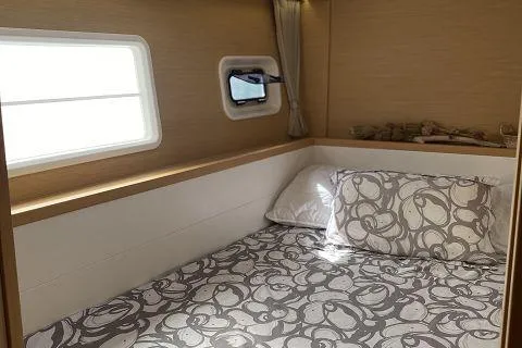 Seafox 1 Yacht Photos Pics Cozy cabin interior of 2015 Lagoon 400 S2 yacht with patterned bedding and natural light.