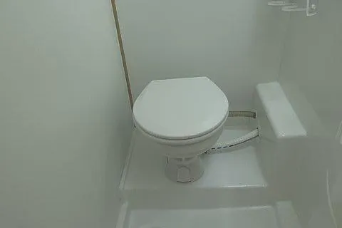 Seafox 1 Yacht Photos Pics 2015 Lagoon 400 S2 yacht bathroom with compact white toilet.