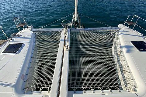 Seafox 1 Yacht Photos Pics 2015 Lagoon 400 S2 catamaran with netted deck, moored on calm blue water.