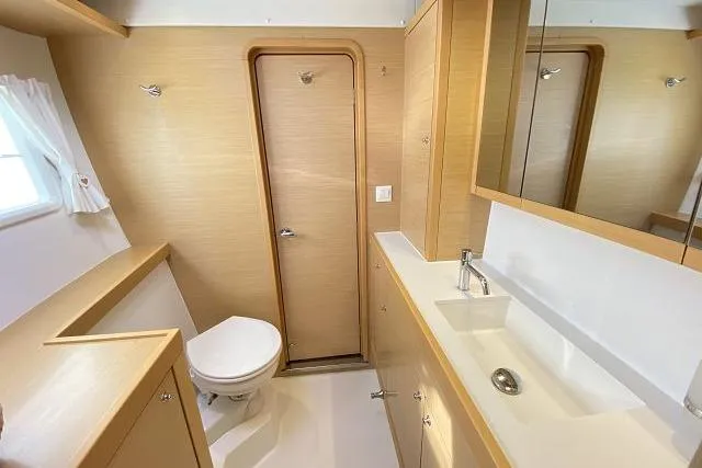 Seafox 1 Yacht Photos Pics Bathroom interior of 2015 Lagoon 400 S2 yacht, featuring modern fixtures and wood accents.