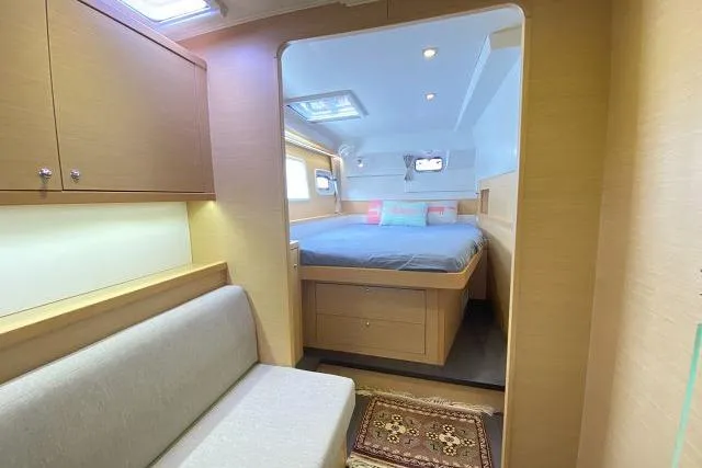 Seafox 1 Yacht Photos Pics Interior of 2015 Lagoon 400 S2 yacht, featuring cozy bedroom and seating area.