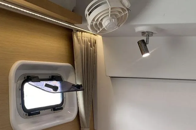 Seafox 1 Yacht Photos Pics Interior of 2015 Lagoon 400 S2 yacht with window, curtain, fan, and light fixture.