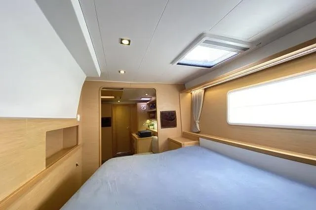 Seafox 1 Yacht Photos Pics Interior of 2015 Lagoon 400 S2 yacht cabin with bed and window.