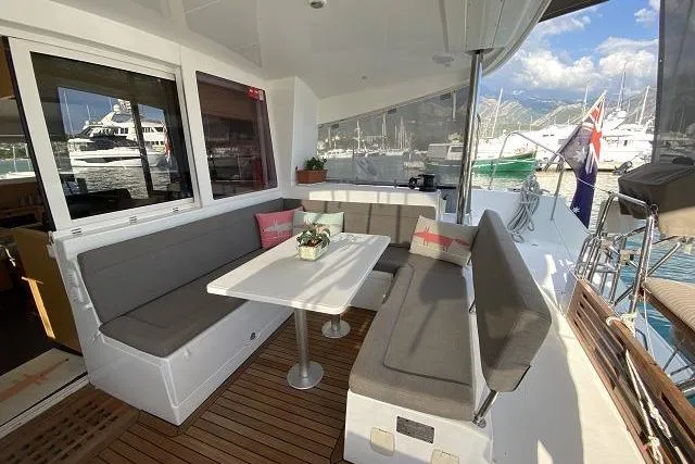 Seafox 1 Yacht Photos Pics 2015 Lagoon 400 S2 yacht with cozy outdoor seating and marina view.