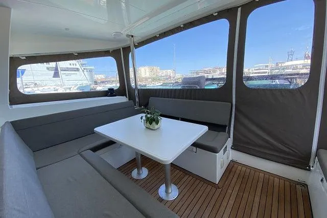 Seafox 1 Yacht Photos Pics 2015 Lagoon 400 S2 yacht interior with seating, table, and marina view.