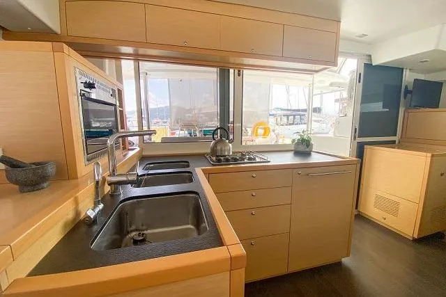 Seafox 1 Yacht Photos Pics Modern kitchen interior of 2015 Lagoon 400 S2 catamaran with dual sinks and ample storage.