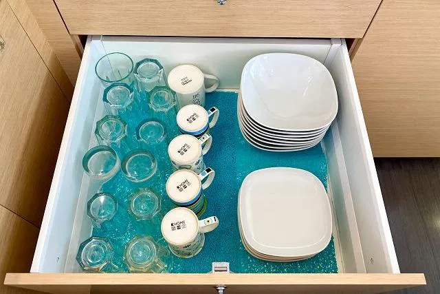 Seafox 1 Yacht Photos Pics Organized kitchen drawer with glasses, mugs, and plates on a blue liner. Lagoon 400 S2, 2015.