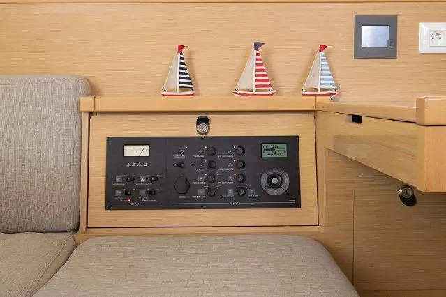 Seafox 1 Yacht Photos Pics Control panel of a 2015 Lagoon 400 S2 yacht with decorative sailboat models.