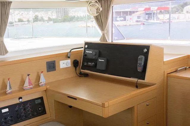 Seafox 1 Yacht Photos Pics Interior view of 2015 Lagoon 400 S2 yacht's navigation station with equipment and scenic window view.