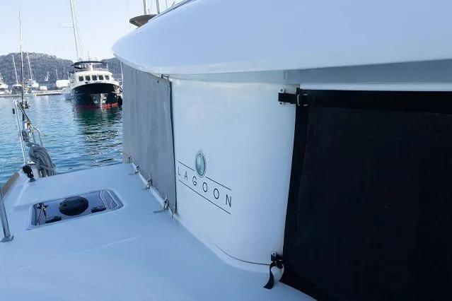 Seafox 1 Yacht Photos Pics 2015 Lagoon 400 S2 catamaran docked in a marina, featuring sleek design and branding.