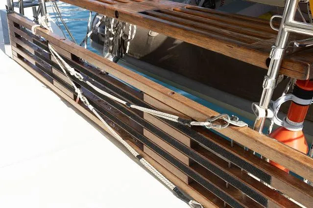 Seafox 1 Yacht Photos Pics Wooden deck detail of 2015 Lagoon 400 S2 catamaran with safety ropes and hardware.