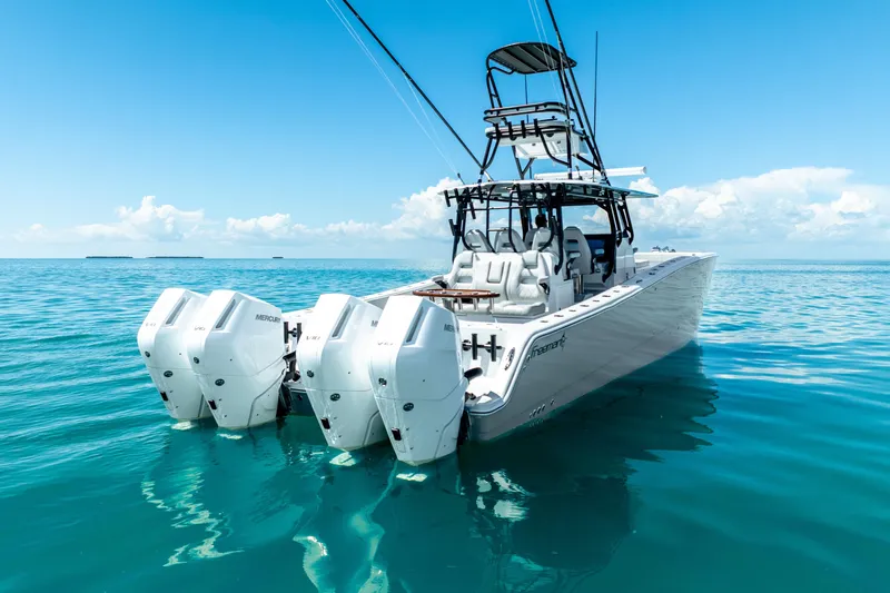  Yacht Photos Pics 2024 Freeman 42 boat with multiple engines on clear blue water.