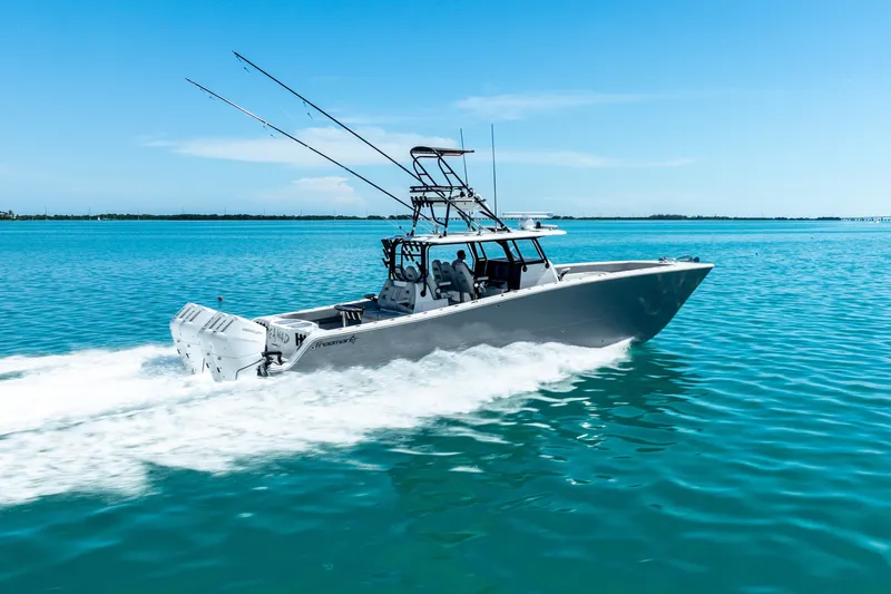  Yacht Photos Pics 2024 Freeman 42 boat cruising on clear blue water under a sunny sky.