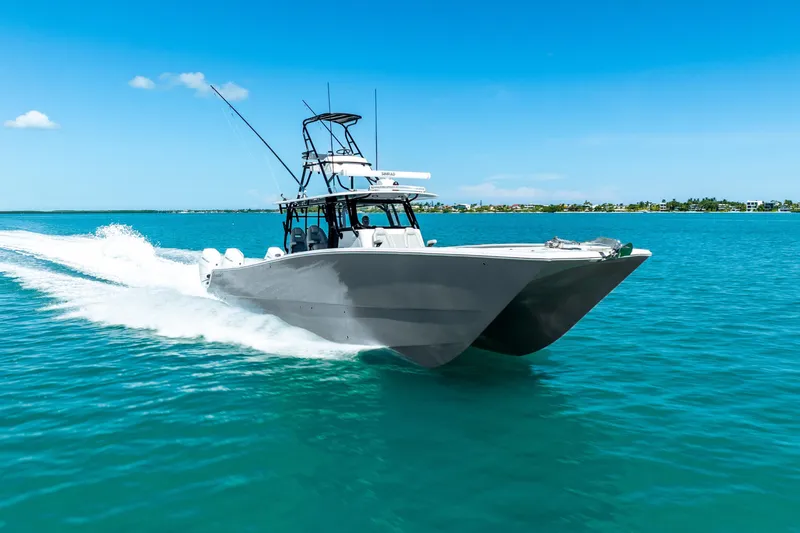  Yacht Photos Pics 2024 Freeman 42 boat cruising on clear blue water under a sunny sky.