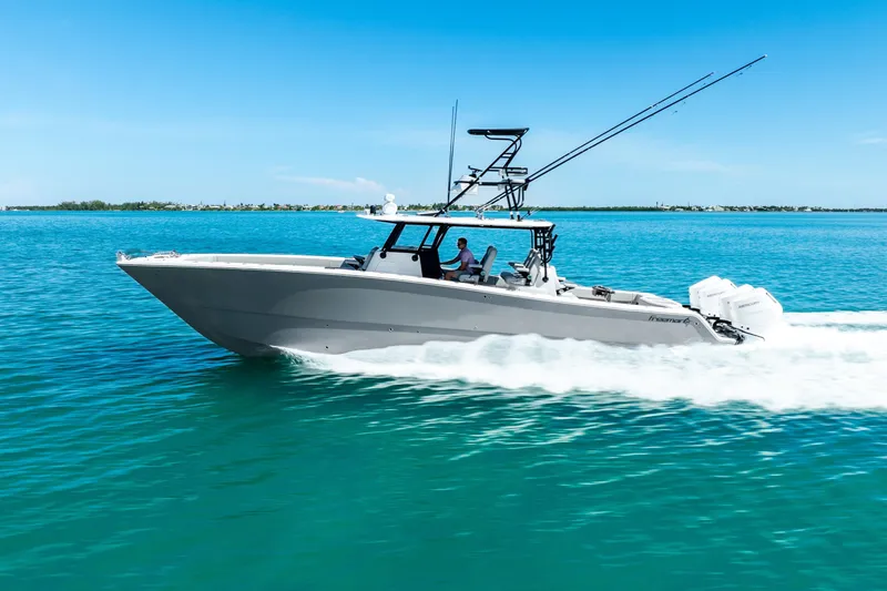  Yacht Photos Pics 2024 Freeman 42 boat cruising on clear blue water under a sunny sky.