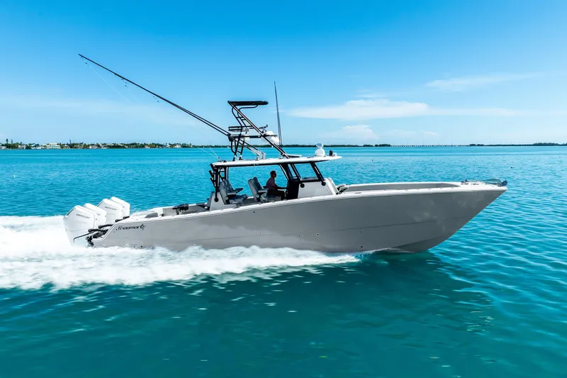  Yacht Photos Pics 2024 Freeman 42 boat cruising on clear blue water under a sunny sky.