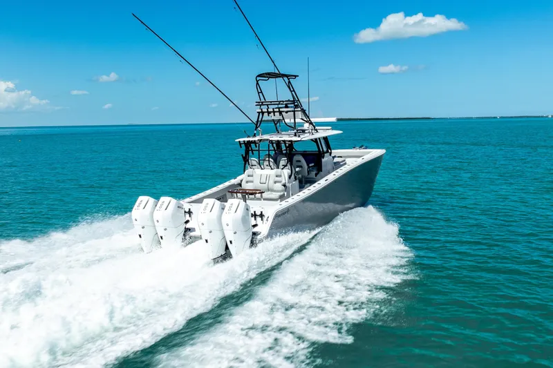  Yacht Photos Pics 2024 Freeman 42 boat cruising on clear blue ocean waters.