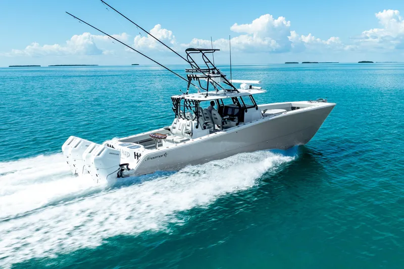  Yacht Photos Pics 2024 Freeman 42 boat cruising on clear blue ocean waters.