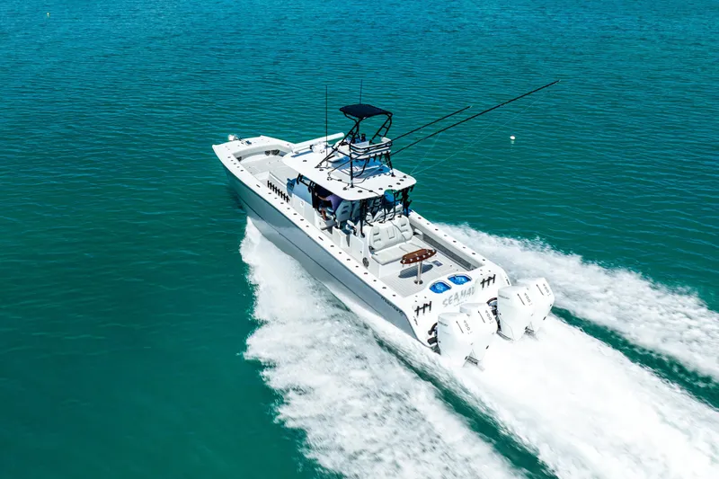  Yacht Photos Pics 2024 Freeman 42 boat cruising on clear blue water, showcasing powerful twin engines.