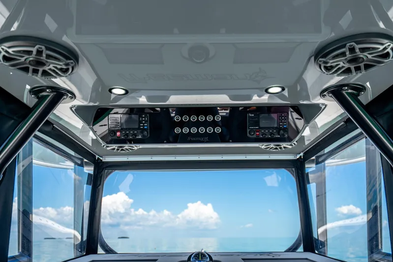 Yacht Photos Pics Interior view of 2024 Freeman 42 boat cockpit with navigation equipment and ocean backdrop.