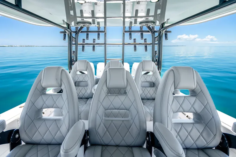  Yacht Photos Pics Luxurious interior of 2024 Freeman 42 boat with diamond-stitched seats on calm ocean.