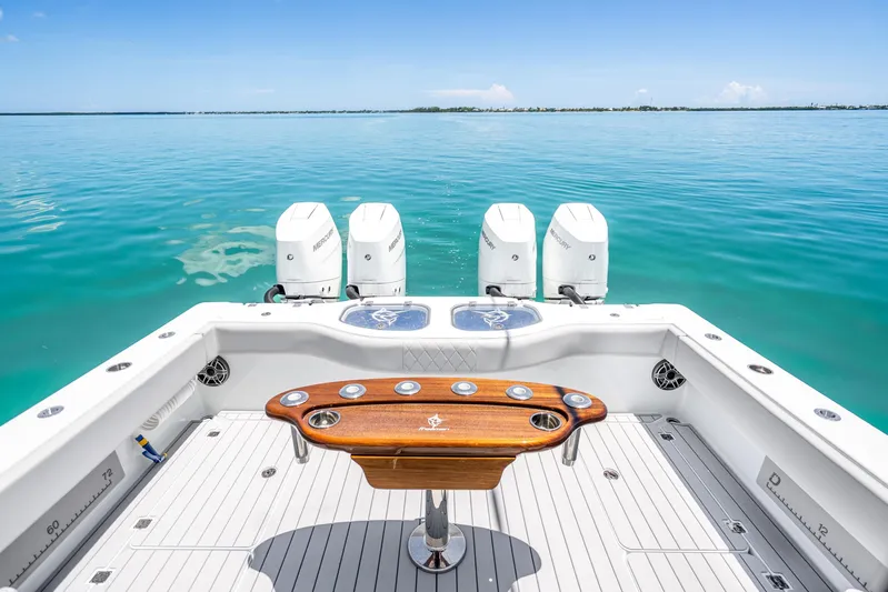  Yacht Photos Pics 2024 Freeman 42 boat with four engines, wooden table, and ocean view.
