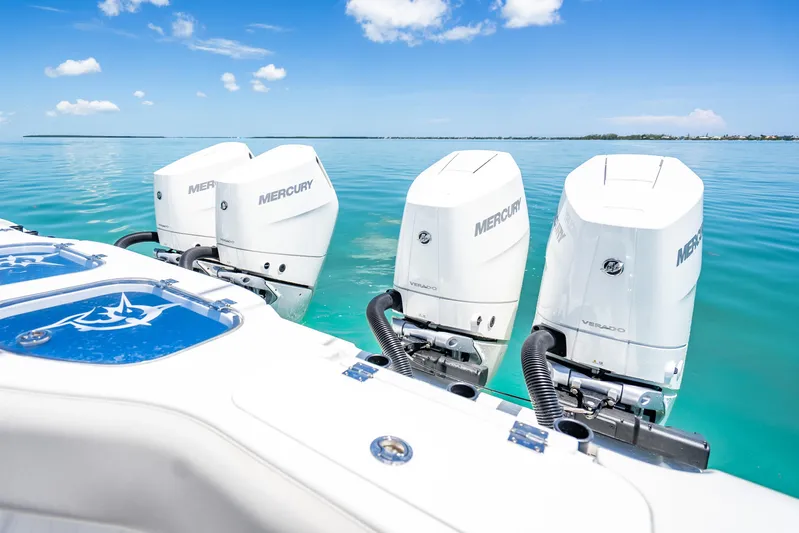  Yacht Photos Pics 2024 Freeman 42 boat with triple Mercury Verado engines on clear blue water.