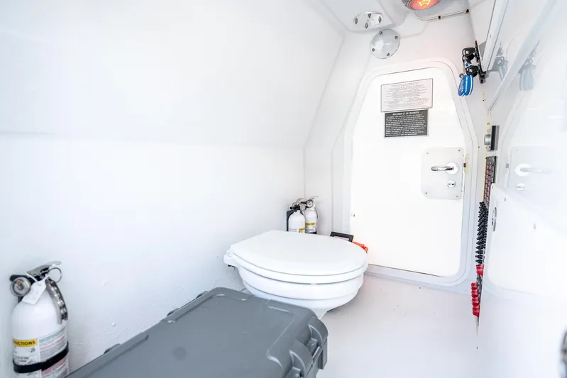  Yacht Photos Pics 2024 Freeman 42 boat interior with toilet, fire extinguishers, and storage compartment.