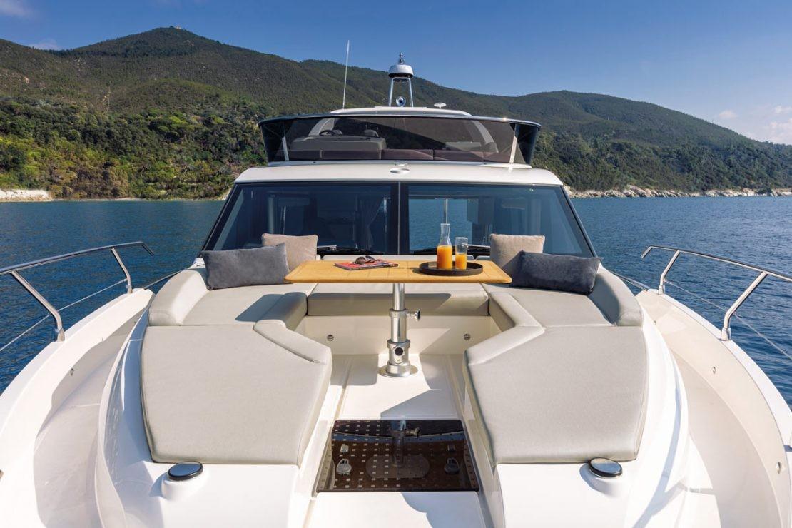 2025 Absolute 47 Fly yacht with luxurious deck seating and scenic ocean view.