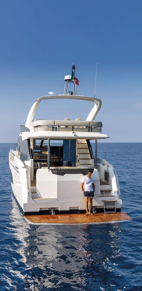 Luxury Absolute 47 Fly yacht, 2025 model, cruising on open sea with clear blue skies.