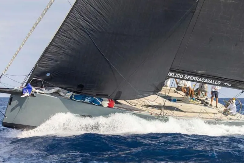 Manti Yacht Photos Pics Sailing yacht Mylius 60, 2019 model, cutting through ocean waves with crew on deck.
