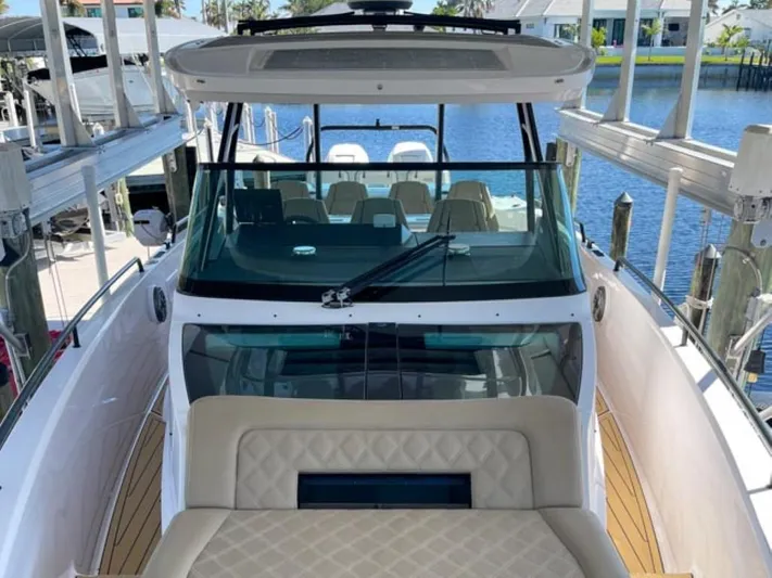  Yacht Photos Pics 2021 Axopar 37 Sun Top BRABUS Trim boat docked, featuring sleek design and spacious seating.