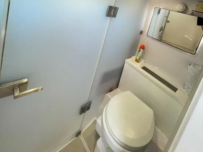  Yacht Photos Pics 2021 Axopar 37 Sun Top BRABUS Trim boat bathroom with modern fixtures and mirror.