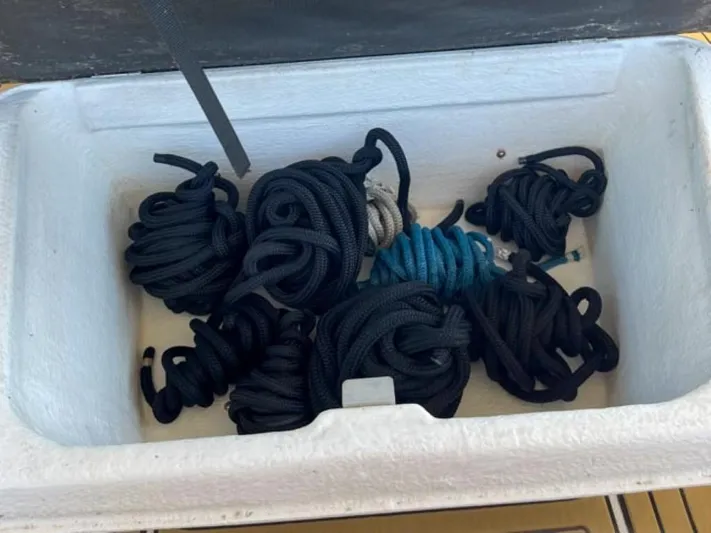  Yacht Photos Pics Coiled ropes stored in a compartment of a 2021 Axopar 37 Sun Top BRABUS Trim boat.