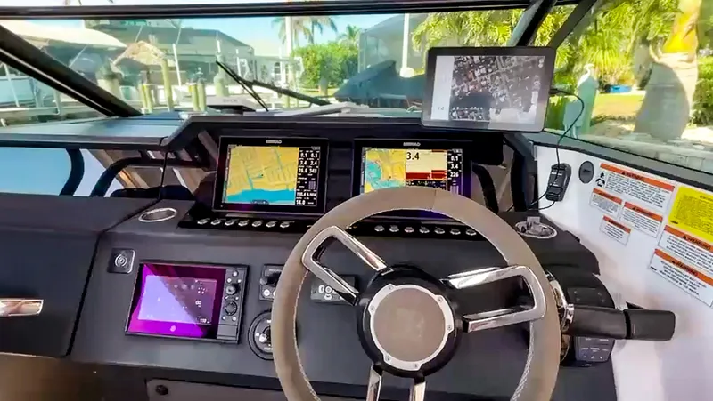  Yacht Photos Pics Cockpit of 2021 Axopar 37 Sun Top BRABUS Trim with advanced navigation displays.