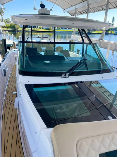  Yacht Photos Pics 2021 Axopar 37 Sun Top BRABUS Trim boat docked by a serene waterfront.