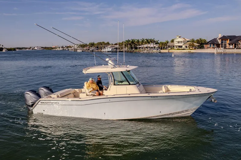  Yacht Photos Pics 2022 Grady-White Canyon 336 boat cruising on a scenic waterway.
