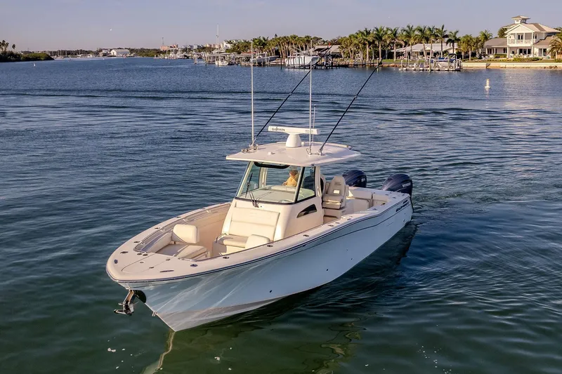  Yacht Photos Pics 2022 Grady-White Canyon 336 boat cruising on a serene waterway.