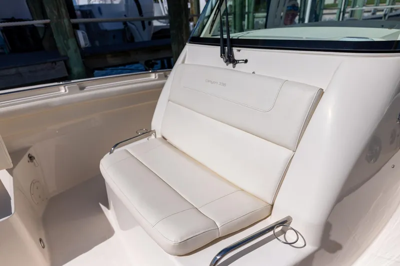  Yacht Photos Pics 2022 Grady-White Canyon 336 boat seating area with white cushioned bench.