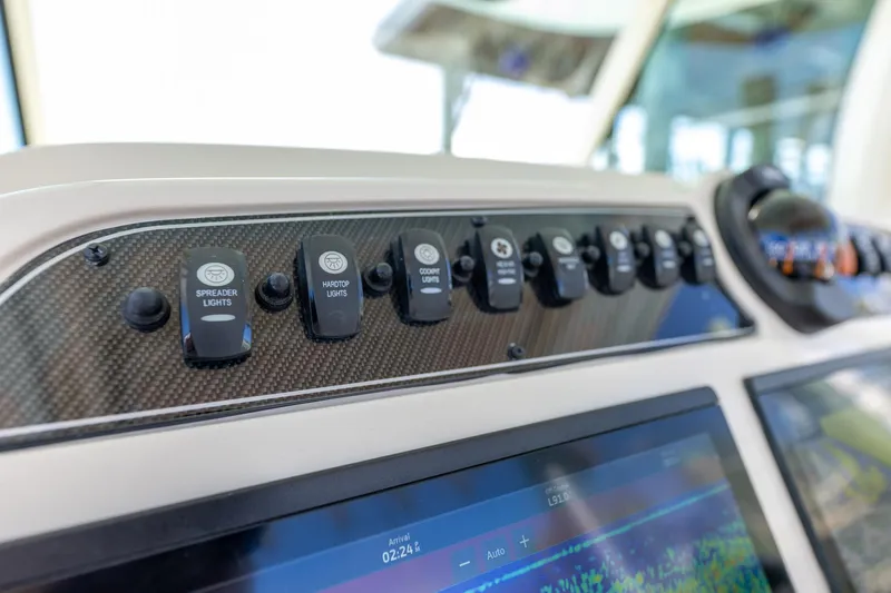  Yacht Photos Pics Control panel of 2022 Grady-White Canyon 336 boat with labeled switches and display.
