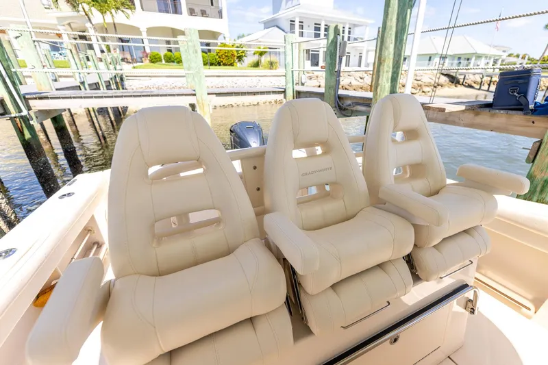  Yacht Photos Pics Luxury seating on 2022 Grady-White Canyon 336 boat, docked by waterfront homes.