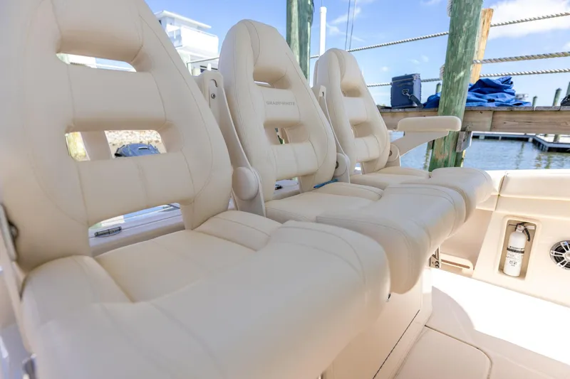  Yacht Photos Pics Luxurious seating on 2022 Grady-White Canyon 336 boat, docked by the water.
