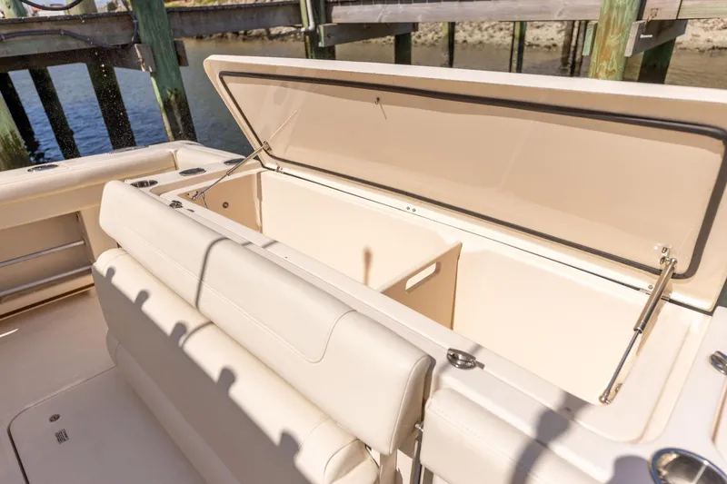  Yacht Photos Pics 2022 Grady-White Canyon 336 boat with open storage compartment, dockside view.