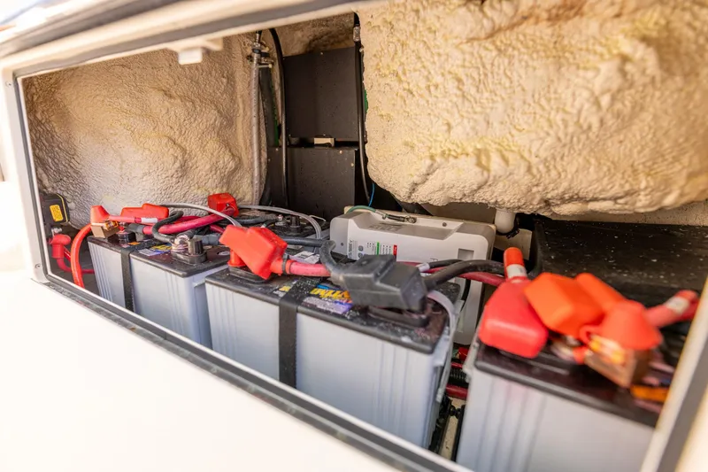  Yacht Photos Pics Battery compartment of 2022 Grady-White Canyon 336 boat, showing multiple connected batteries.